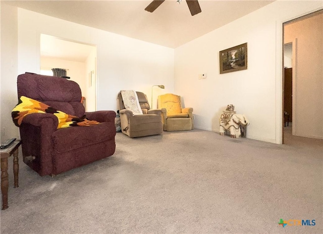 sitting room with ceiling fan and carpet flooring