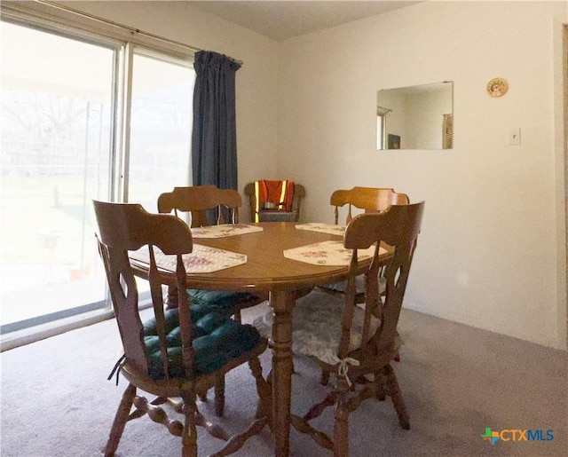 dining space with plenty of natural light and carpet floors