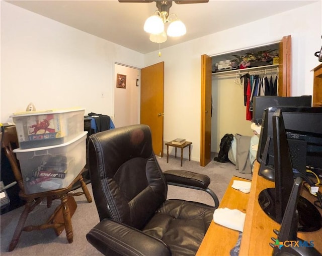 carpeted office featuring ceiling fan