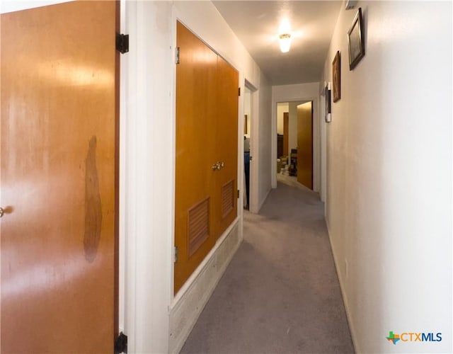 hall featuring visible vents and light colored carpet