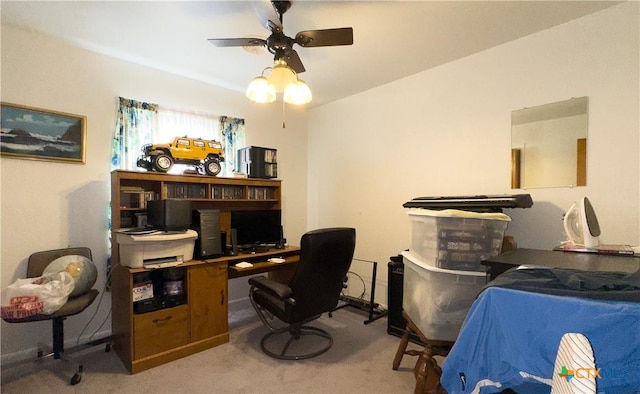 carpeted office with a ceiling fan