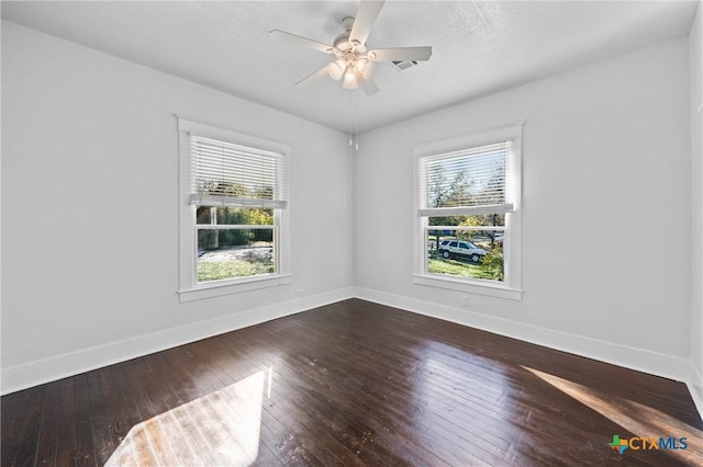 unfurnished room featuring hardwood / wood-style floors, ceiling fan, and a wealth of natural light