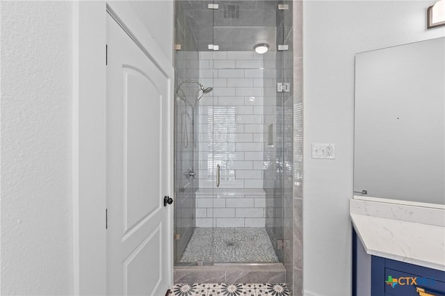 bathroom with vanity and a shower with door