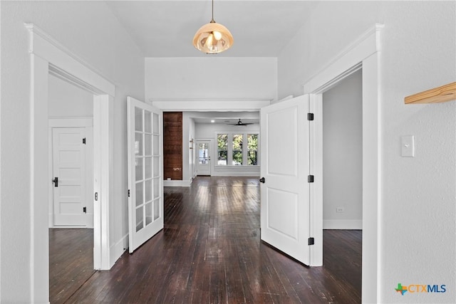 corridor featuring dark hardwood / wood-style flooring and french doors