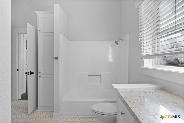 full bathroom with tile patterned flooring, vanity, shower / bath combination, and toilet