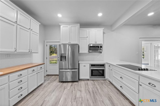 kitchen with light wood-type flooring, backsplash, stainless steel appliances, beam ceiling, and white cabinetry