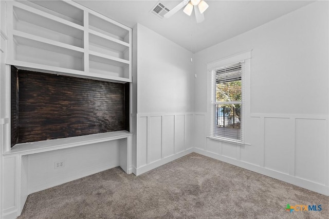 spare room featuring light carpet and ceiling fan