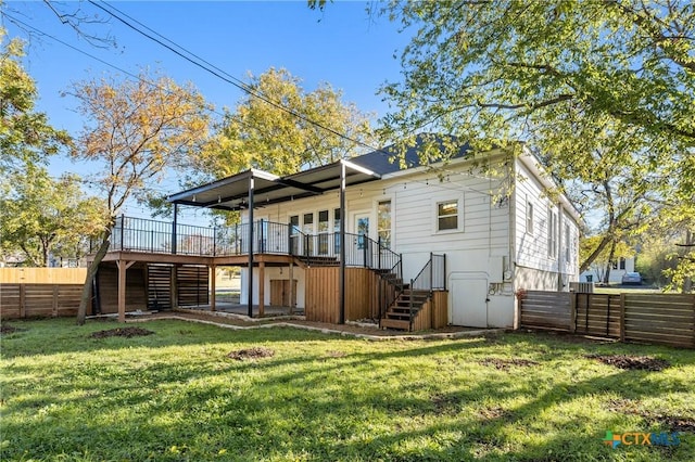 back of property with a wooden deck and a yard