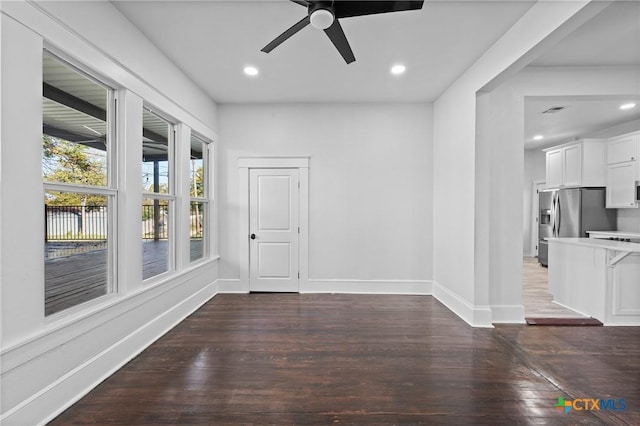 unfurnished room with dark hardwood / wood-style flooring and ceiling fan