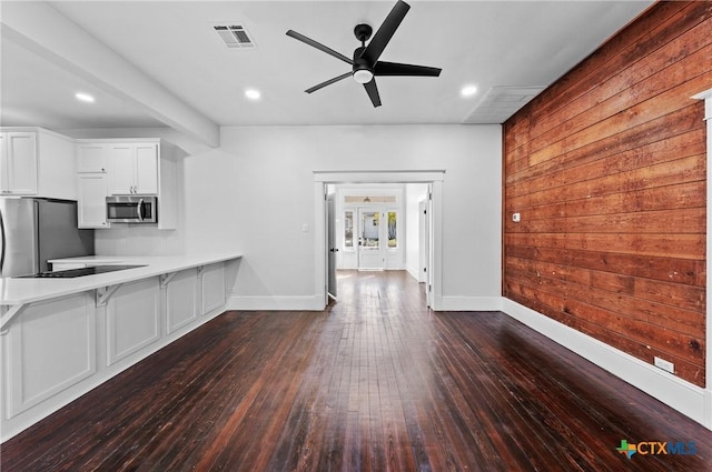 kitchen featuring dark hardwood / wood-style floors, ceiling fan, white cabinetry, and appliances with stainless steel finishes