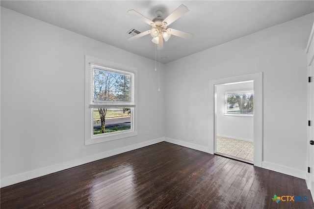 unfurnished room with plenty of natural light, dark hardwood / wood-style floors, and ceiling fan