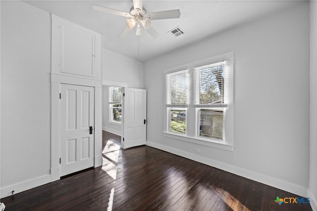 empty room featuring ceiling fan and dark wood-type flooring