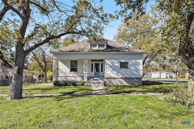 bungalow-style house featuring a front lawn