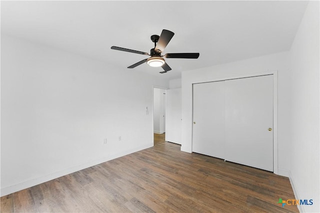 6022 Wildwind Dr, Windcrest, TX 78239 - unfurnished bedroom with wood finished floors, a closet, a ceiling fan, and baseboards