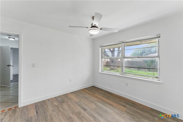 6022 Wildwind Dr, Windcrest, TX 78239 - unfurnished room with wood finished floors, baseboards, and a ceiling fan