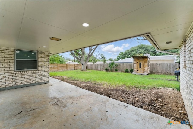 6022 Wildwind Dr, Windcrest, TX 78239 - view of patio featuring a storage unit and an outdoor structure