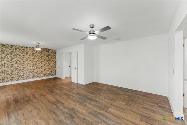 6022 Wildwind Dr, Windcrest, TX 78239 - empty room featuring wallpapered walls, wood finished floors, ceiling fan, and baseboards
