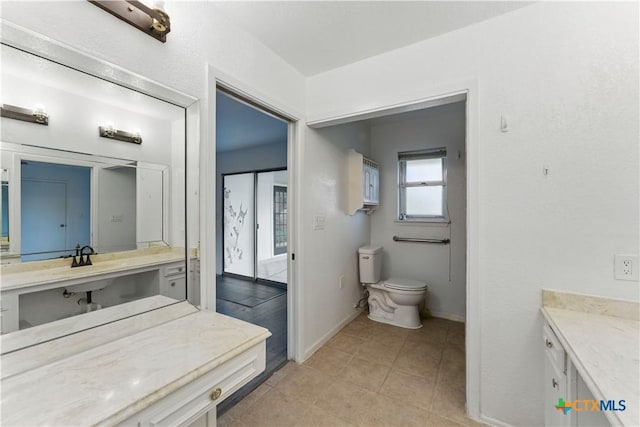 6022 Wildwind Dr, Windcrest, TX 78239 - bathroom featuring toilet, vanity, baseboards, and tile patterned floors