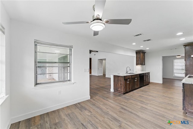 6022 Wildwind Dr, Windcrest, TX 78239 - kitchen featuring a sink, dark brown cabinetry, light countertops, a ceiling fan, and wood finished floors