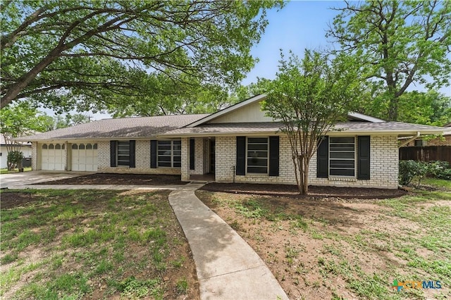 6022 Wildwind Dr, Windcrest, TX 78239 - ranch-style house with a garage, brick siding, fence, concrete driveway, and covered porch