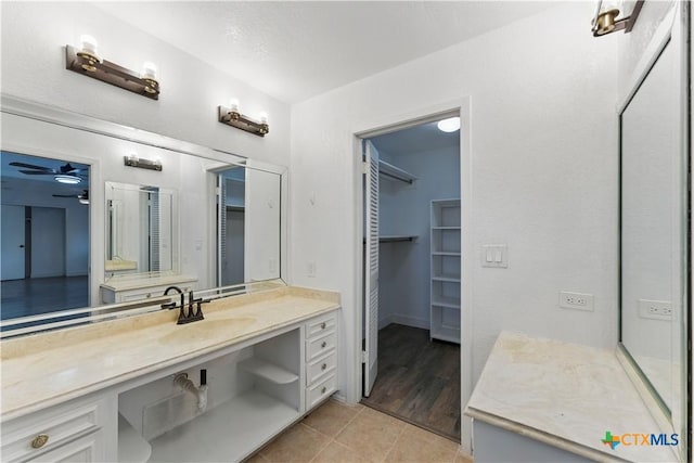 6022 Wildwind Dr, Windcrest, TX 78239 - bathroom with tile patterned flooring, vanity, and a walk in closet