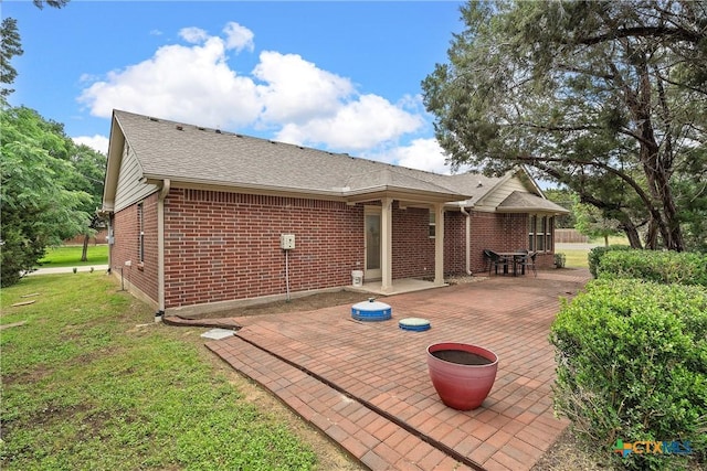 back of property featuring a yard and a patio area