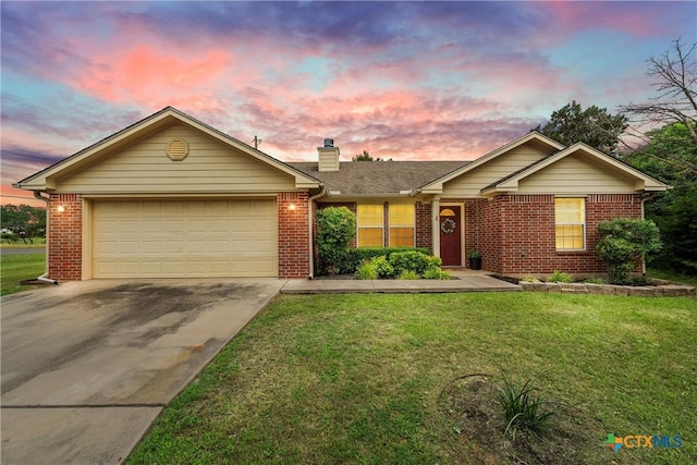 ranch-style home with a yard and a garage