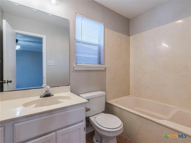 full bathroom with ceiling fan, washtub / shower combination, tile patterned floors, toilet, and vanity