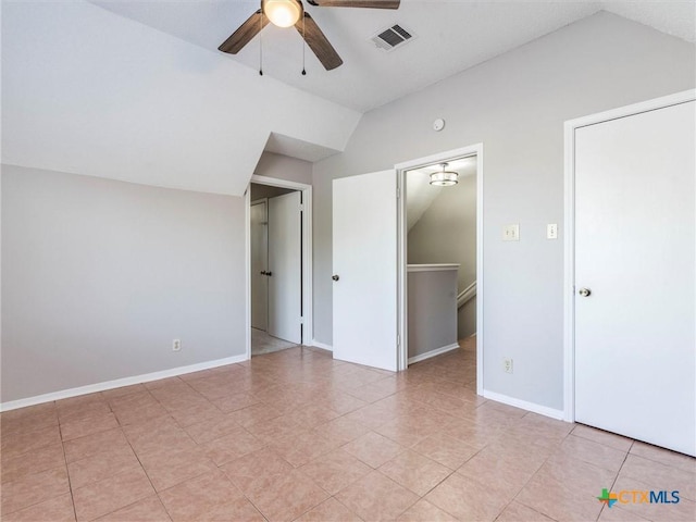 interior space featuring ceiling fan, a walk in closet, and lofted ceiling