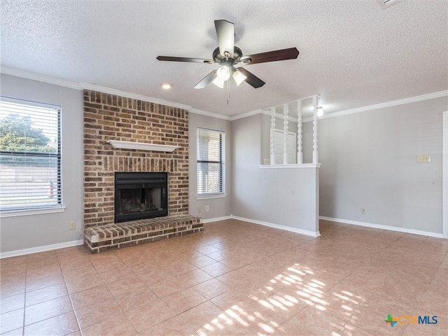 unfurnished living room featuring ceiling fan, plenty of natural light, crown molding, and a brick fireplace