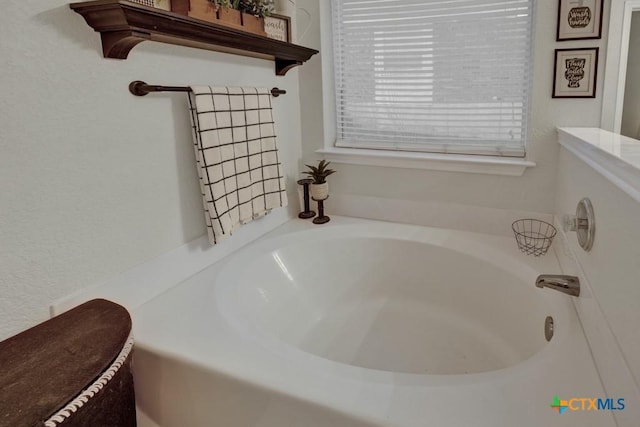 bathroom with a tub to relax in