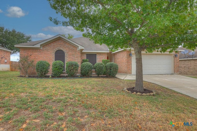 view of front of home with a garage and a front lawn