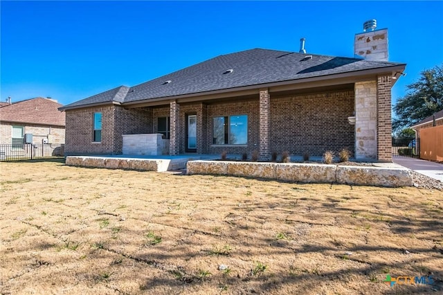 rear view of house with a yard and a patio area