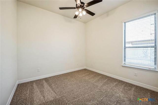 carpeted spare room with ceiling fan