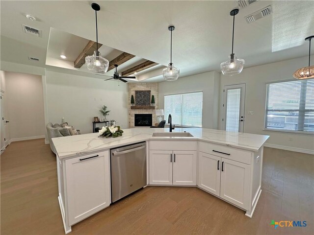 4316 Sunflower Ln, Temple, TX 76502 - kitchen featuring stainless steel dishwasher, open floor plan, ceiling fan, a fireplace, and light wood finished floors