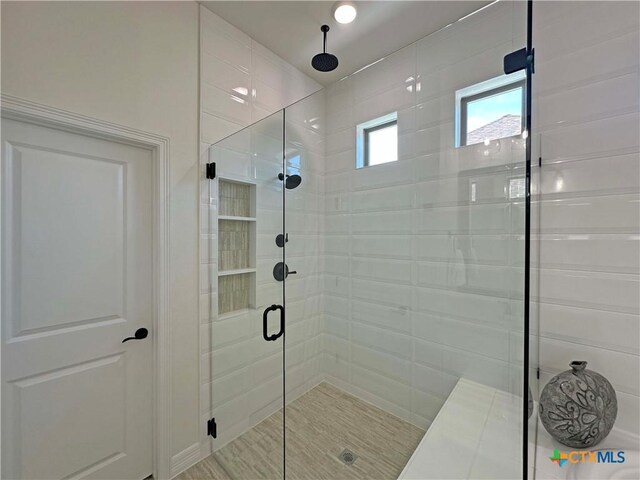 4316 Sunflower Ln, Temple, TX 76502 - bathroom with a garden tub and wood finished floors