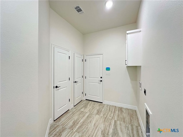 4316 Sunflower Ln, Temple, TX 76502 - washroom featuring electric dryer hookup, light wood finished floors, and cabinet space