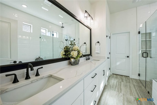 bathroom with vanity and a shower with shower door