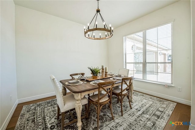 dining room with an inviting chandelier, hardwood / wood-style flooring, and a healthy amount of sunlight