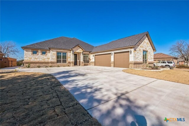 view of front of home with a garage and a front lawn