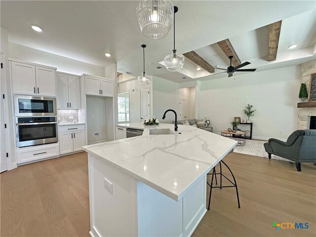 4316 Sunflower Ln, Temple, TX 76502 - laundry room with cabinet space, electric dryer hookup, light wood-style floors, and washer hookup
