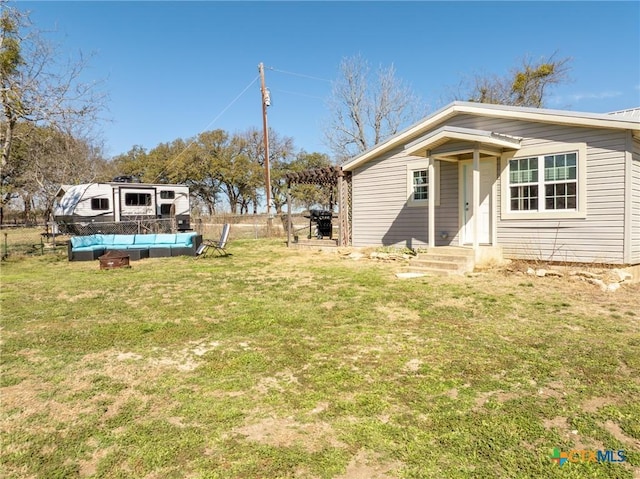 rear view of property featuring a yard, fence, and a fenced in pool