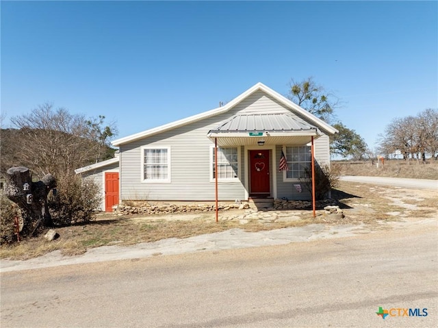 bungalow featuring metal roof