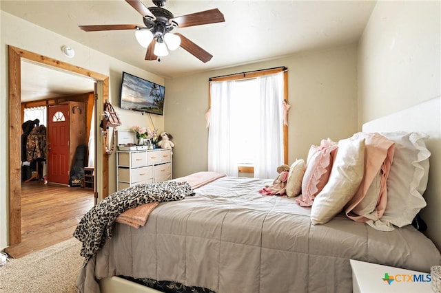 bedroom featuring a ceiling fan and wood finished floors