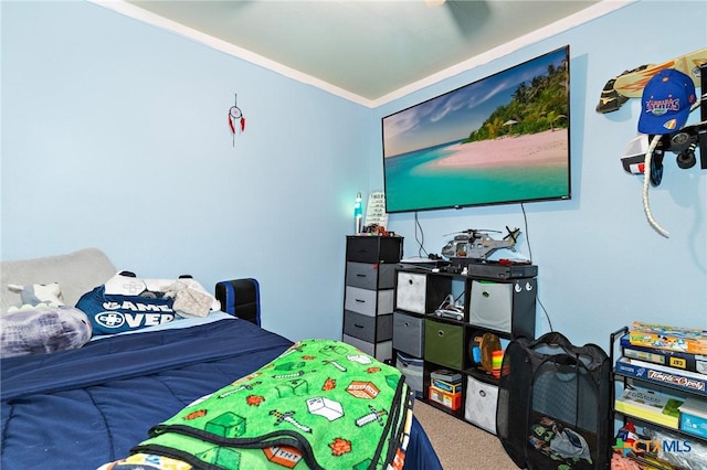 bedroom with carpet flooring and crown molding