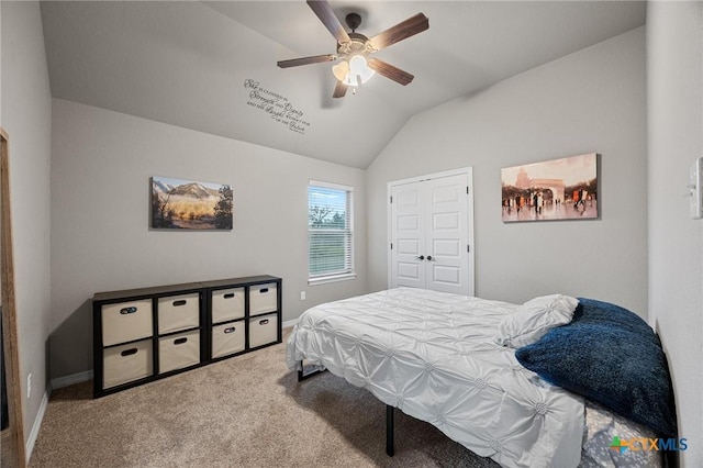 carpeted bedroom with vaulted ceiling, a ceiling fan, and baseboards