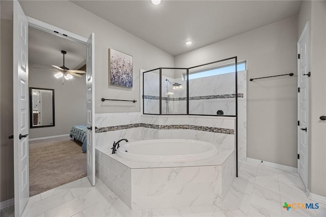 bathroom with a garden tub, marble finish floor, a ceiling fan, a walk in shower, and baseboards