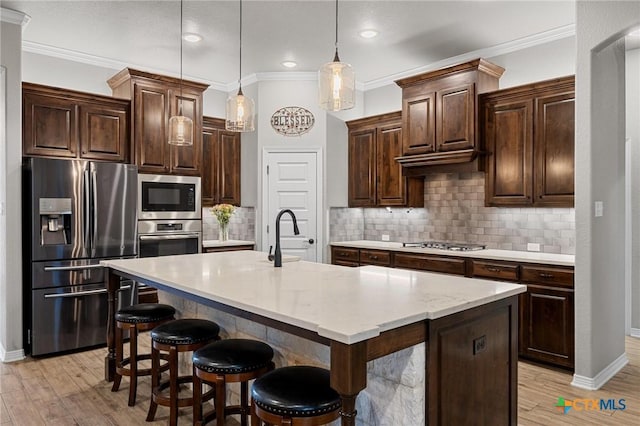 kitchen featuring decorative backsplash, light wood-style flooring, stainless steel appliances, and crown molding