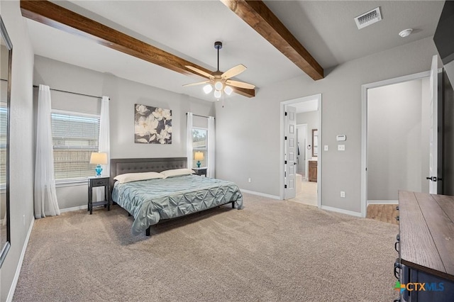 bedroom featuring baseboards, visible vents, carpet floors, ensuite bath, and beam ceiling