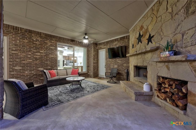 view of patio / terrace featuring an outdoor living space with a fireplace and a ceiling fan